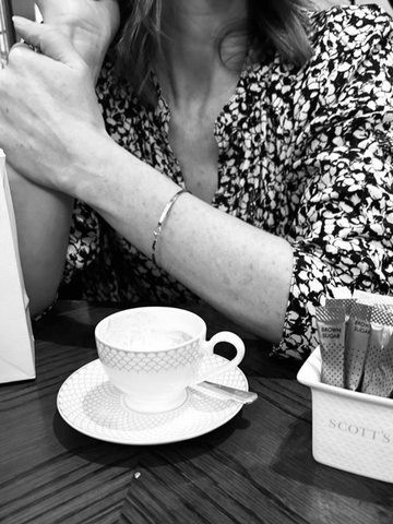 Close up model wearing gold dainty bracelet