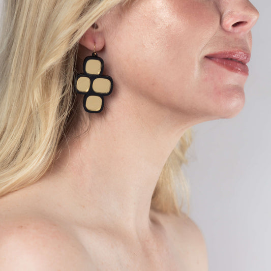 Model wearing mirror statement wire earrings