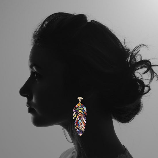 Woman wearing Tutti Frutti colourful leaf earrings, colourful earrings by Hélène Elisabeth, Rêves de Paradis collection
