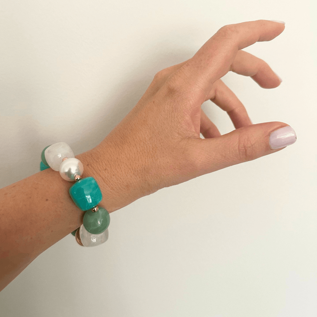 Woman wearing ocean turquoise statement beaded bracelet, gold plated, Douceur Acidulée collection by Hélène Elisabeth