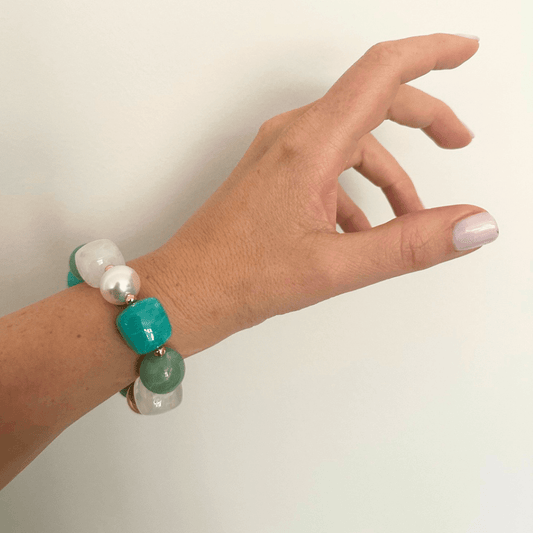Woman wearing ocean turquoise statement beaded bracelet, gold plated, Douceur Acidulée collection by Hélène Elisabeth