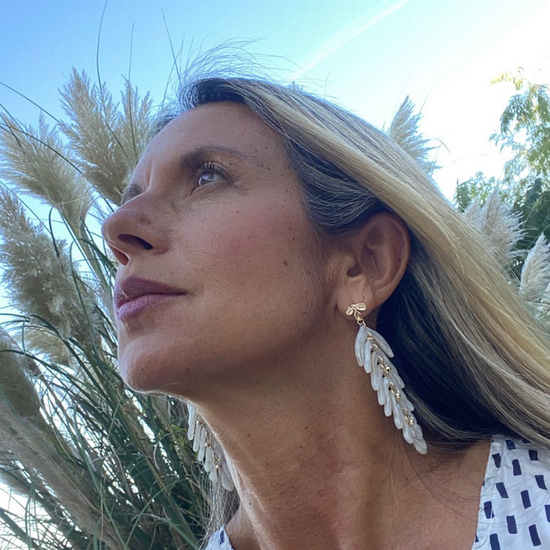 Woman wearing pearl white leaf earrings, wedding guest earrings by Hélène Elisabeth, Rêves de Paradis collection